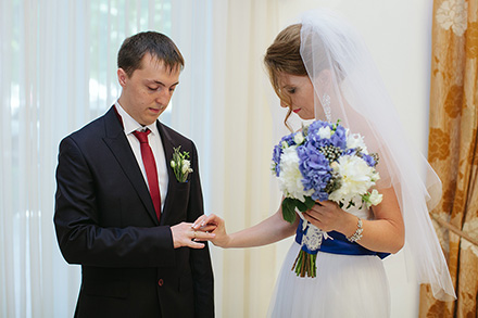 Невеста надевает кольцо жениху